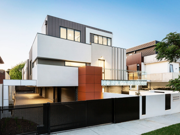 Modern multi-story house with clean lines and large windows at dusk.