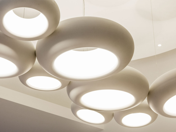 Modern circular ceiling lights glowing softly in a room.