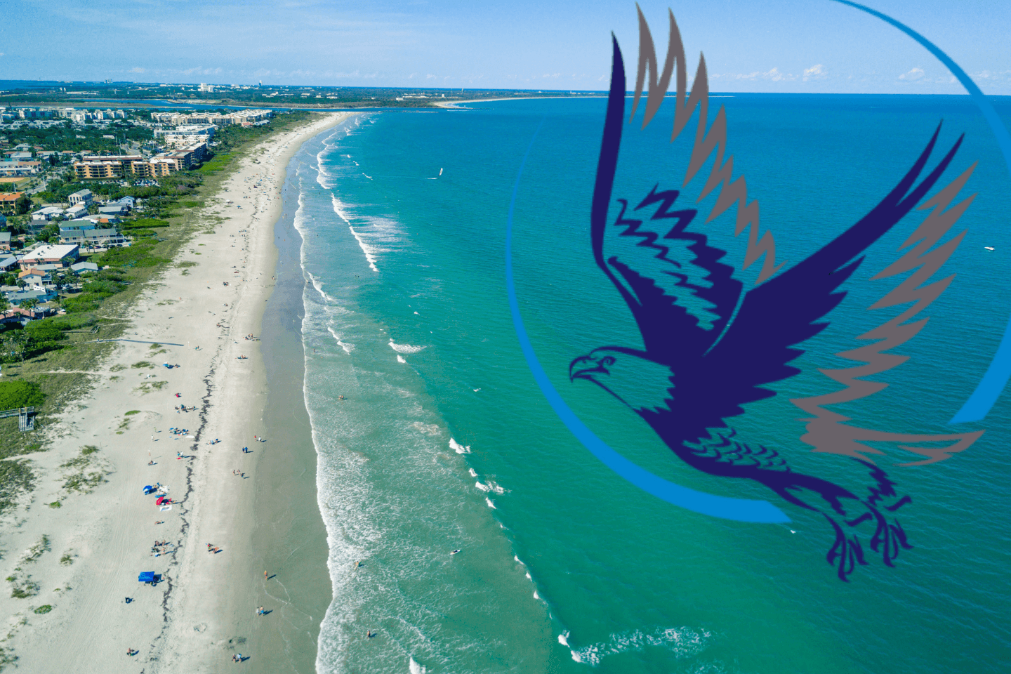 Aerial view of a beach with blue ocean and sandy shore.