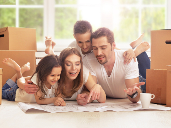 Family planning inside new home with boxes.