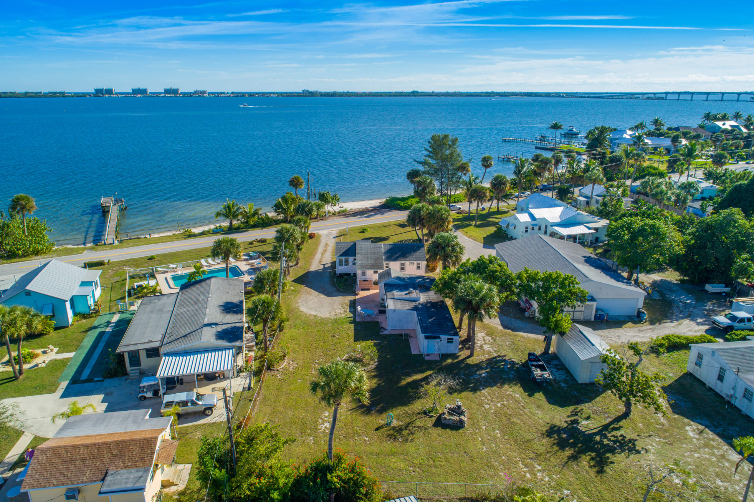Aerial view of a coastal residential area with houses near the water.