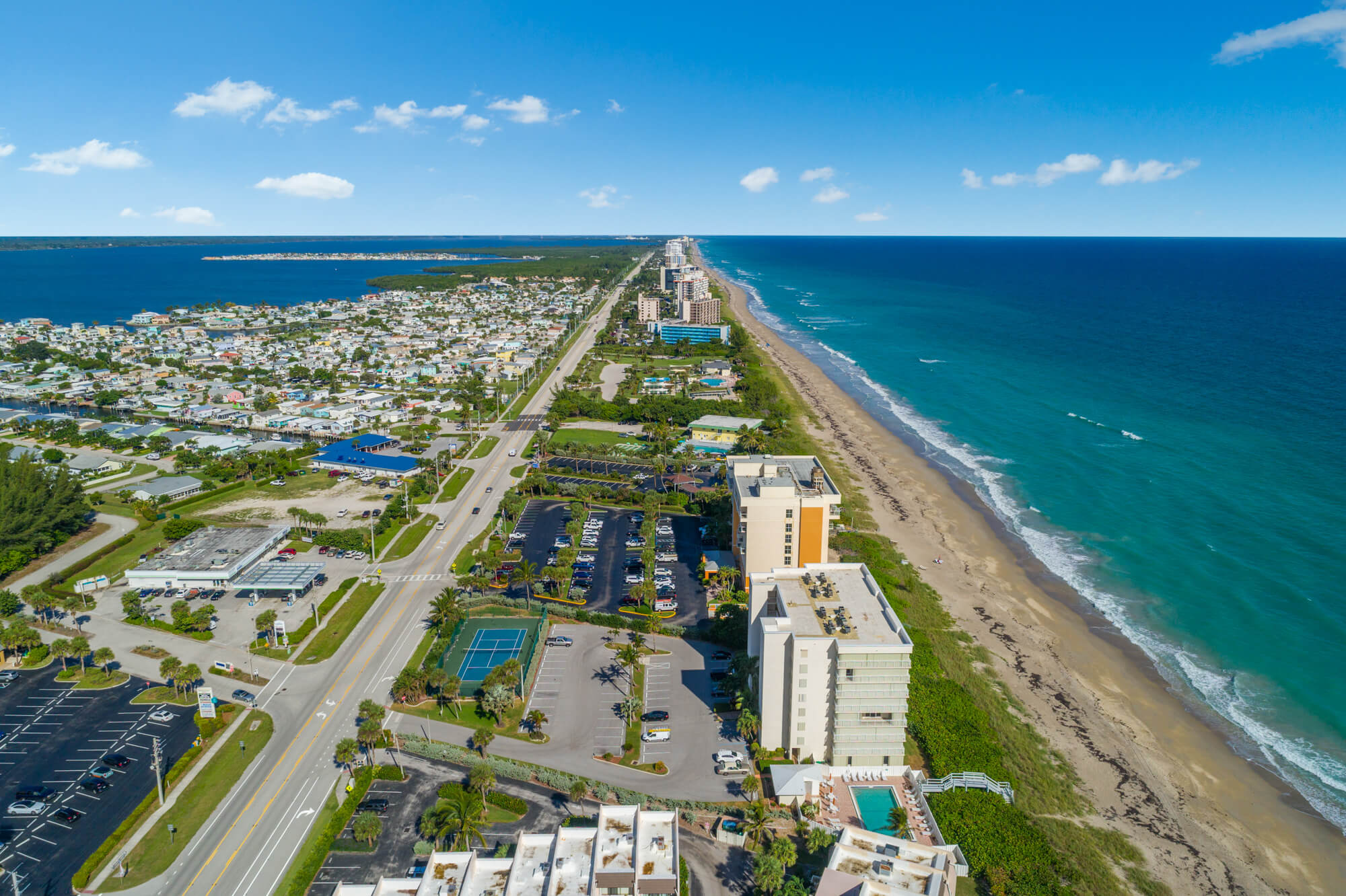 Aerial view of a coastal city with beaches and buildings.