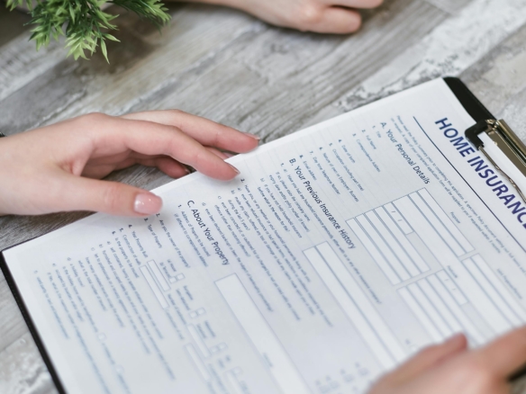 Two people reviewing a detailed form or document together.
