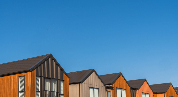 Colorful modern houses against clear blue sky.