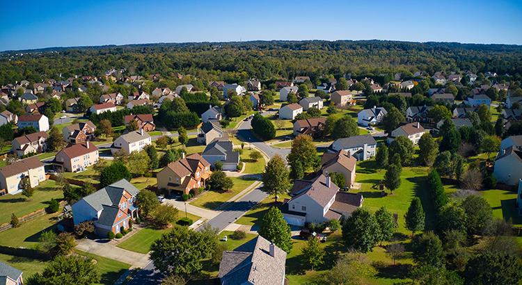 Suburban neighborhood with houses and green trees.
