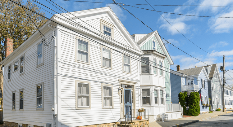 White and blue houses on suburban street.