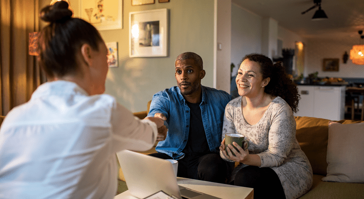 Couple meeting with advisor at home.
