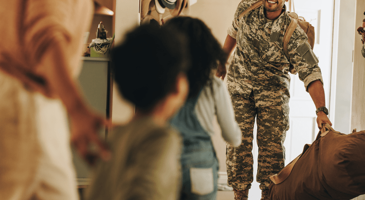 Soldier returning home to family, smiling.